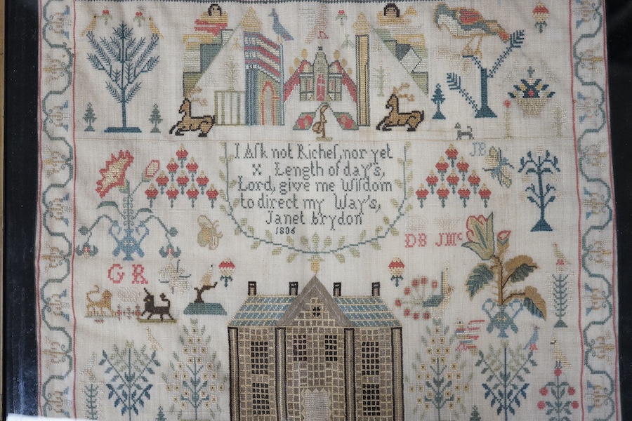 A George lll needlework sampler dated 1806, by Janet Brydon. Worked on fine linen, the sampler embroidered with ornate motifs of angels, birds, deer, lions and a castle around a short embroidered script; I ask not riches